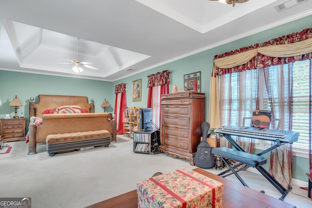 bedroom featuring a raised ceiling, ornamental molding, multiple windows, and visible vents