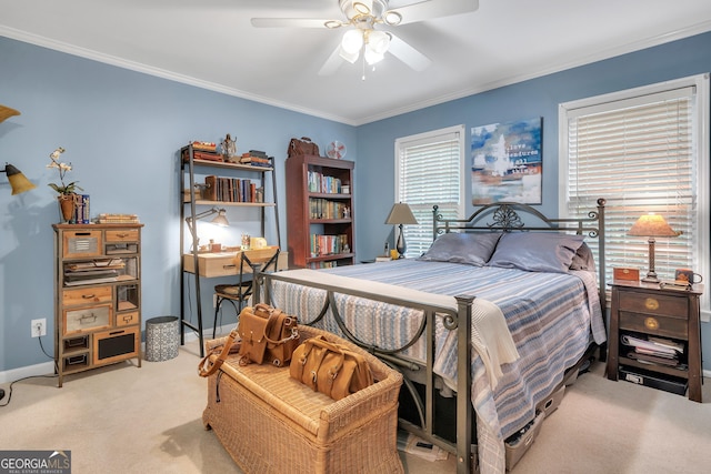 bedroom featuring ceiling fan, crown molding, light colored carpet, and baseboards