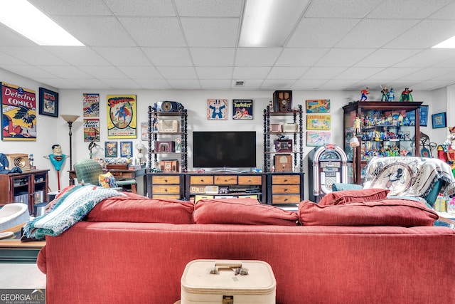 living room featuring a drop ceiling