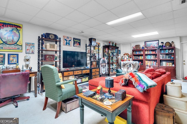 living area with a paneled ceiling