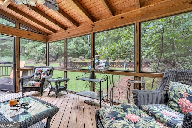 sunroom with a healthy amount of sunlight and beamed ceiling