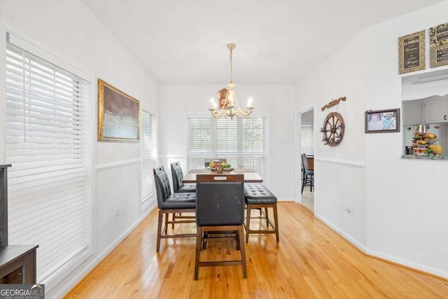 dining room featuring hardwood / wood-style floors and an inviting chandelier