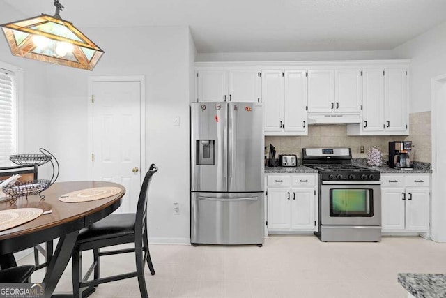 kitchen featuring appliances with stainless steel finishes, white cabinetry, decorative light fixtures, and light stone countertops