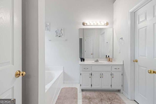 bathroom with vanity, tile patterned floors, and a bathtub