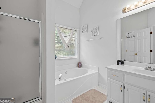 bathroom with tile patterned floors, shower with separate bathtub, and vanity