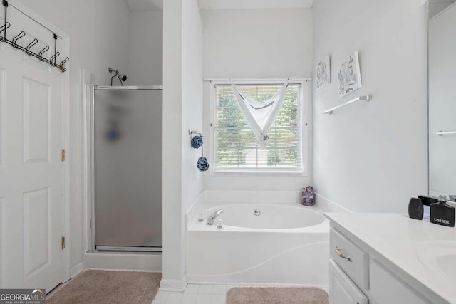 bathroom featuring vanity and shower with separate bathtub