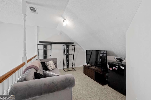 living room with lofted ceiling, light carpet, and a textured ceiling