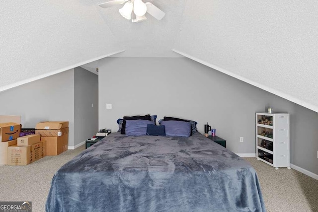 carpeted bedroom with lofted ceiling, ceiling fan, and a textured ceiling