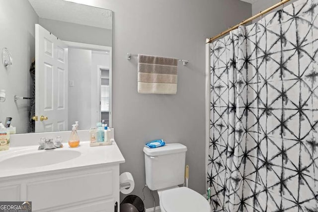 bathroom featuring vanity, toilet, and a shower with shower curtain