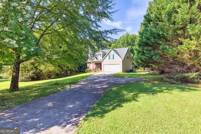 view of front of home featuring a front yard and a garage