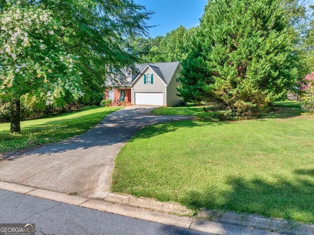 view of front of house featuring a garage and a front yard