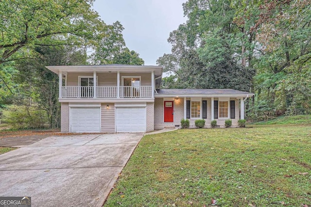 tri-level home with a garage, a porch, and a front lawn