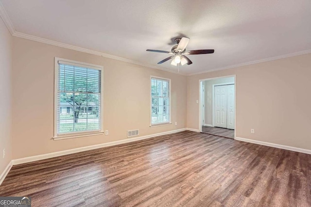 spare room featuring ceiling fan, dark hardwood / wood-style flooring, and ornamental molding