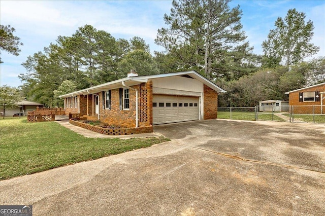 view of side of property with a lawn and a garage