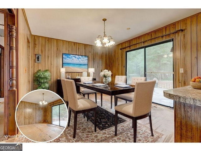 dining room with a chandelier and wooden walls