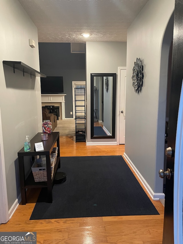 interior space featuring a textured ceiling and light hardwood / wood-style flooring