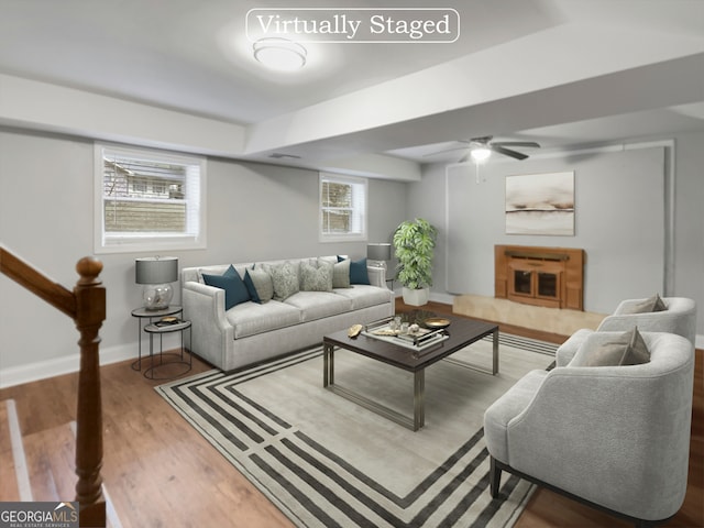 living room featuring wood-type flooring, ceiling fan, and plenty of natural light