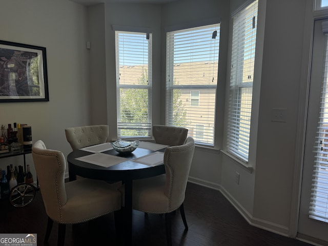 dining room with dark hardwood / wood-style flooring