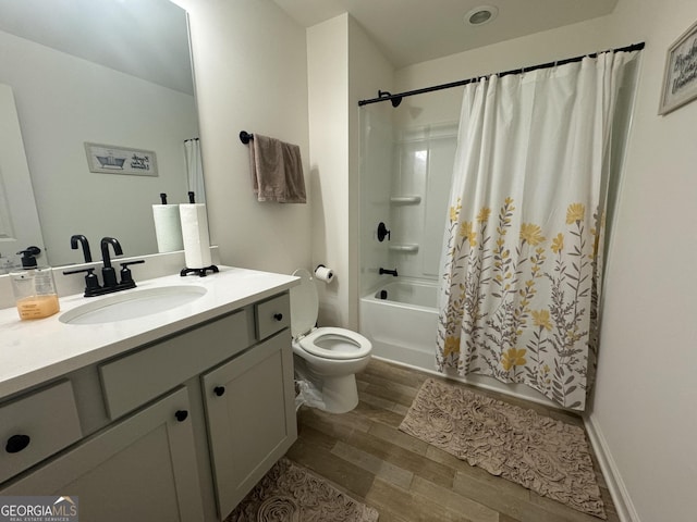 full bathroom featuring wood-type flooring, vanity, toilet, and shower / tub combo