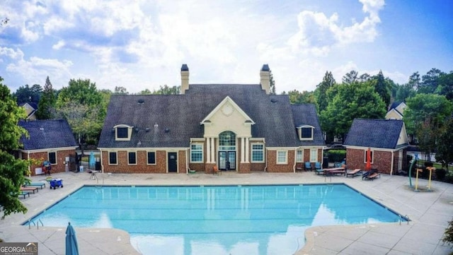 view of swimming pool with a patio