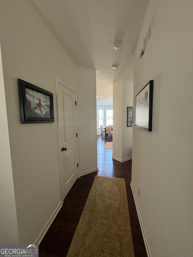 corridor featuring dark wood-type flooring