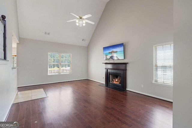 unfurnished living room with ceiling fan, dark hardwood / wood-style flooring, and high vaulted ceiling