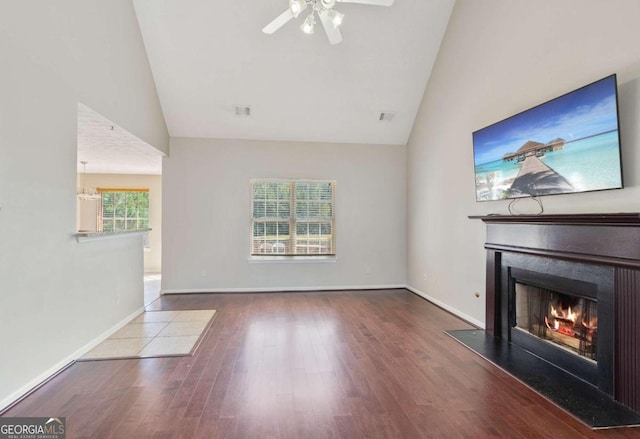 unfurnished living room featuring ceiling fan, hardwood / wood-style flooring, and a wealth of natural light