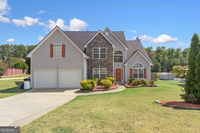 view of property with a garage and a front lawn