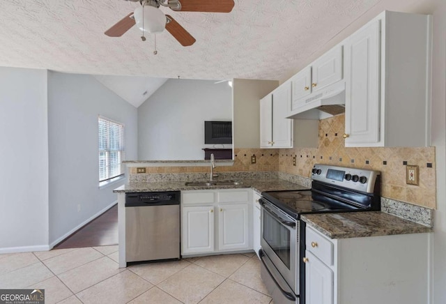 kitchen featuring lofted ceiling, ceiling fan, stainless steel appliances, and white cabinets