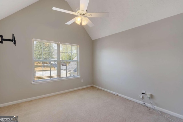 unfurnished room with lofted ceiling, ceiling fan, and light colored carpet