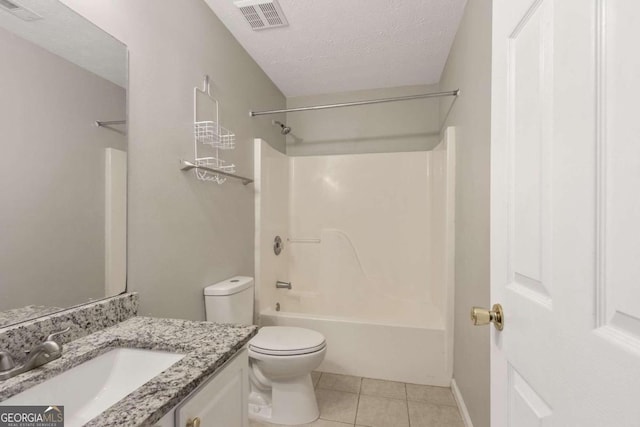 full bathroom with vanity, a textured ceiling, washtub / shower combination, toilet, and tile patterned floors