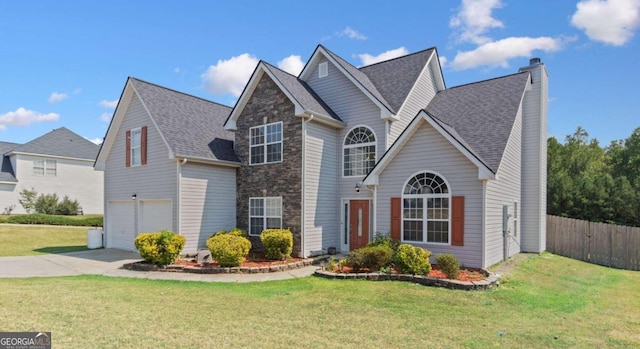 view of property with a front yard and a garage