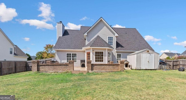 back of house with a lawn, a storage unit, and a patio area