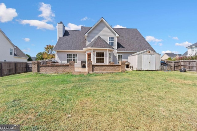 rear view of property featuring a yard and a shed