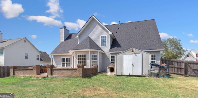 back of property featuring a storage shed and a yard