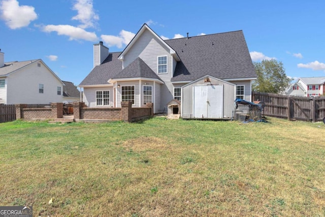 rear view of property featuring a storage shed and a lawn