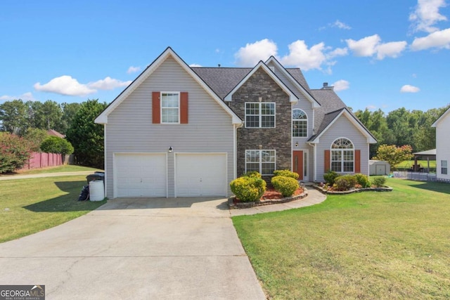 front of property featuring a front yard and a garage