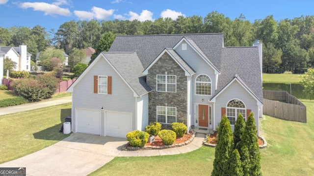 front facade featuring a garage and a front yard