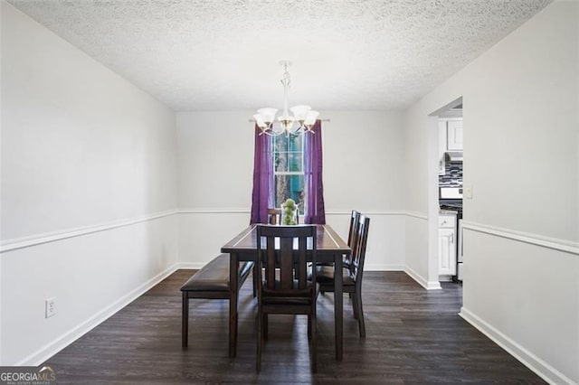 dining space with a textured ceiling, dark wood-type flooring, and a chandelier