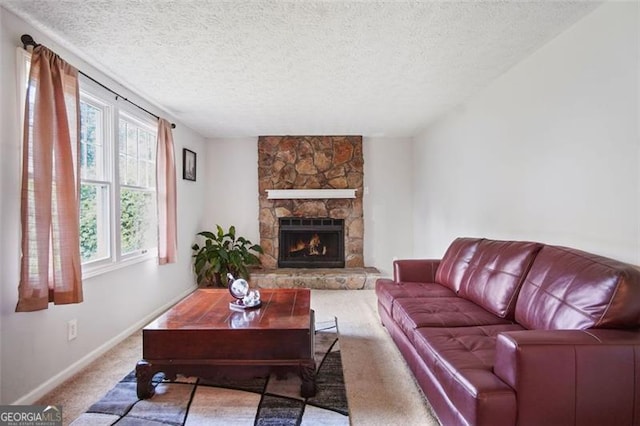 living room featuring a fireplace, carpet flooring, and a textured ceiling