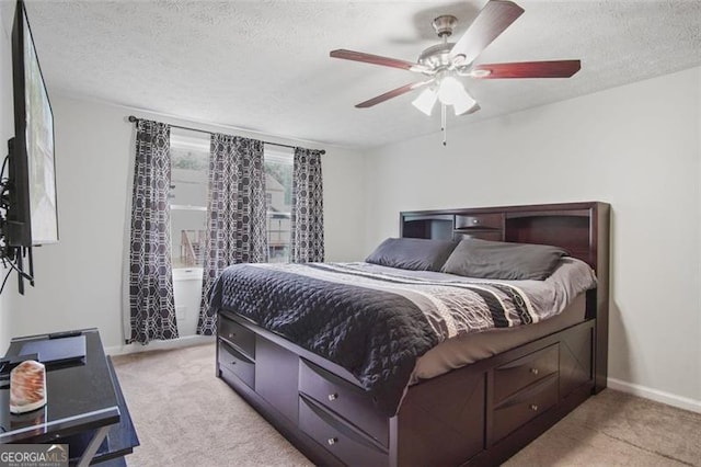 carpeted bedroom with a textured ceiling and ceiling fan