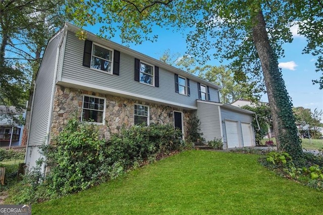 view of front facade with a garage and a front yard