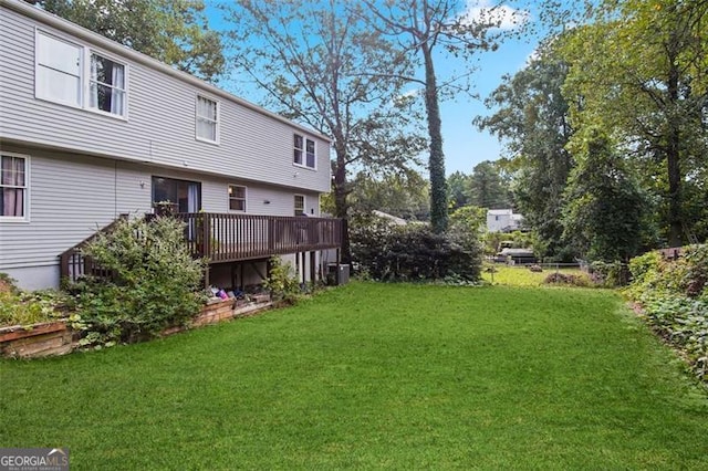 view of yard featuring a wooden deck and central AC