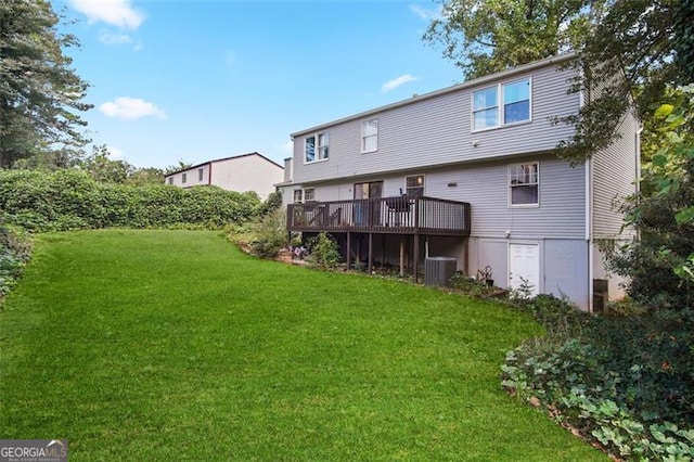 rear view of property with a yard, central AC, and a deck