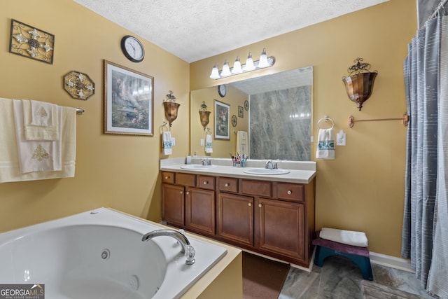 bathroom with a tub, vanity, and a textured ceiling