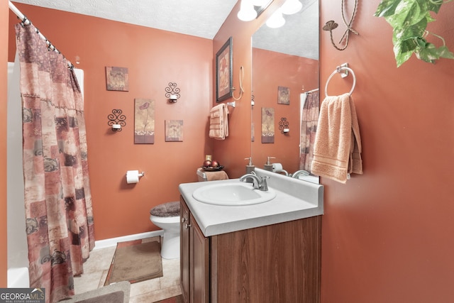 bathroom with tile patterned flooring, toilet, a textured ceiling, and vanity