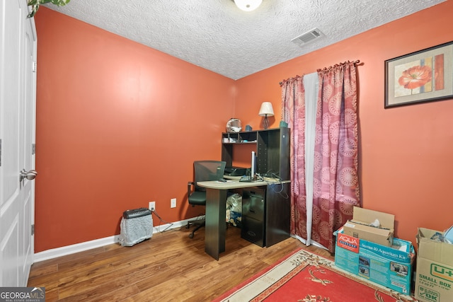 office space with hardwood / wood-style floors and a textured ceiling