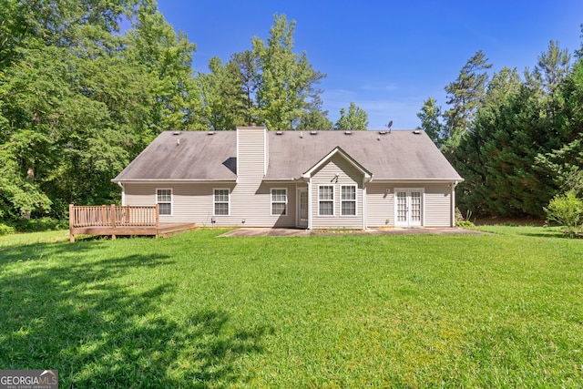 view of front of home with a deck, a front lawn, and a patio