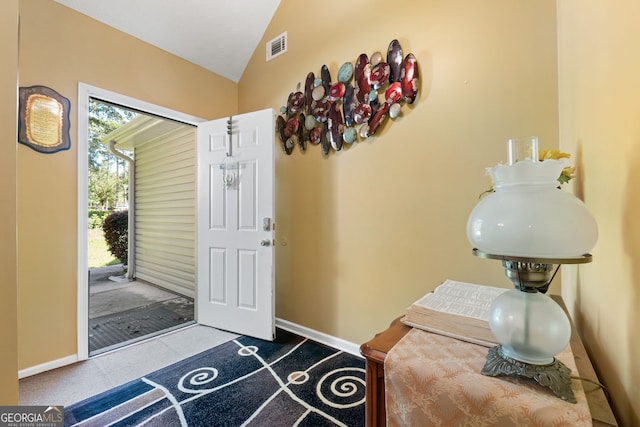 entrance foyer featuring vaulted ceiling