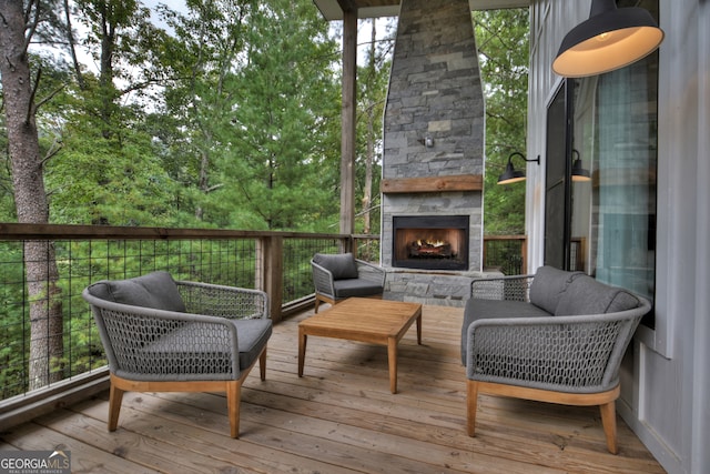 wooden deck with an outdoor living space with a fireplace